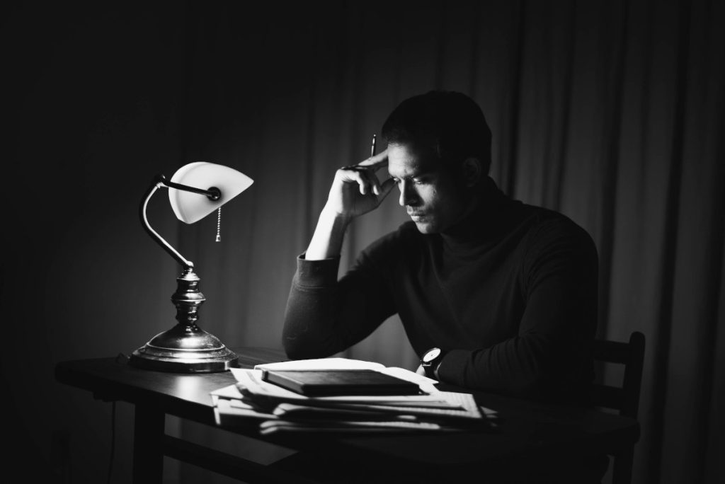 man reading at a desk