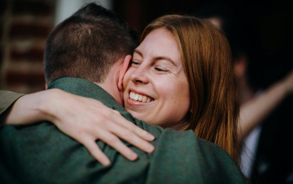 Smiling woman hugging a man