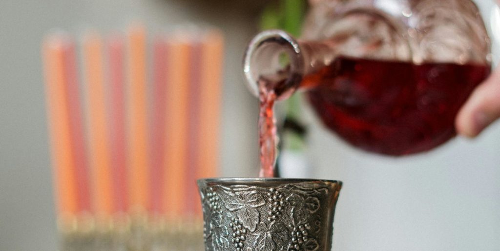 pouring wine into metal cup - abolishing Christmas