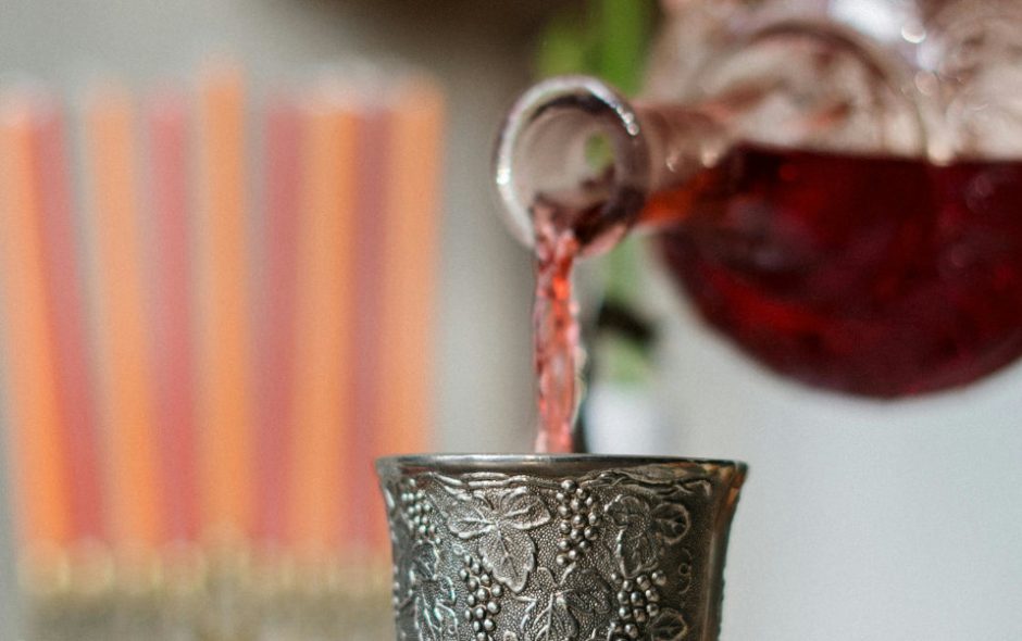 pouring wine into metal cup - abolishing Christmas