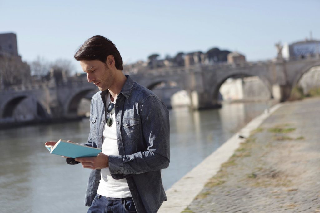Man reading by a river