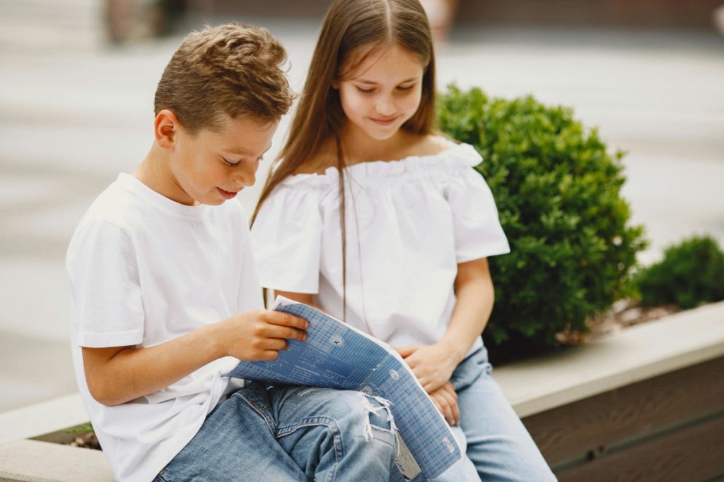 Boy and girl reading outside
