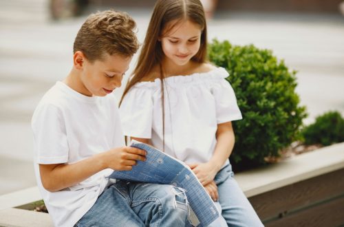 Boy and girl reading outside