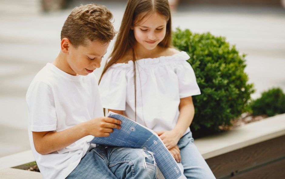 Boy and girl reading outside